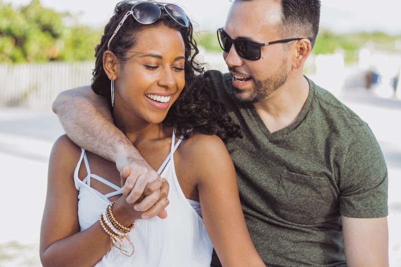 Beautiful couple embracing on shoreline